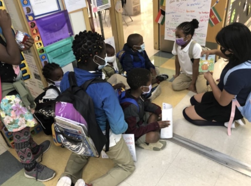 4th Grade Student reading to a class of newcomers.