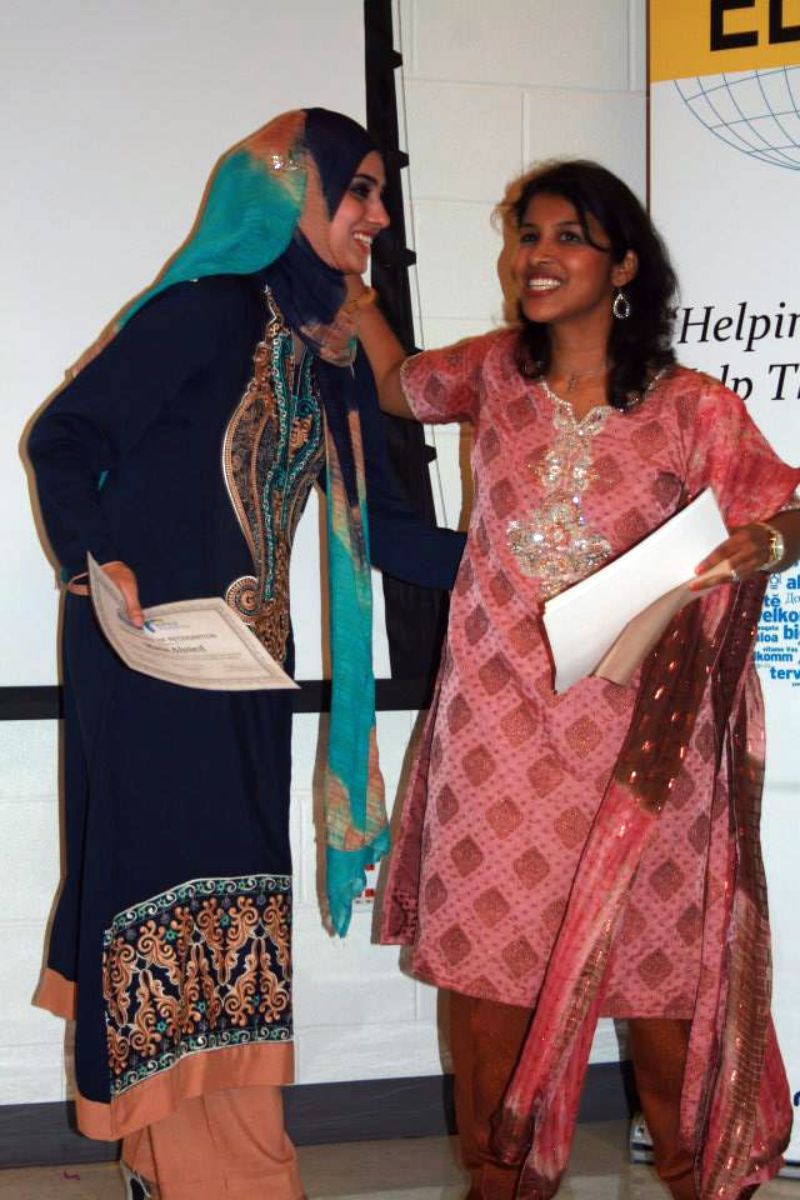 Jackie Cyriac, Parent Mentor Program (PMP) Community Organizer, congratulates Maria Ahmed, Parent Mentor, at their end of year ceremony in 2013. Ahmed represents one of the many diverse faces in Niles Township, Chicago, IL.