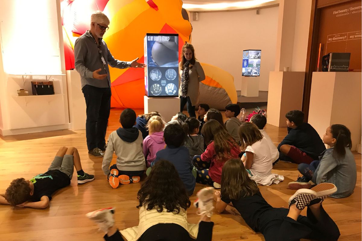 A group of students visiting the exhibit about Home.